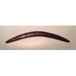 AN EARLY 20TH CENTURY AUSTRALIAN WOODEN BOOMERANG  With carved wriggle work decoration.  (approx