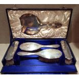 A 20TH CENTURY SILVER TRAVELLING SET To include a mirror, two hairbrushes and two clothes brushes,