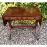 A REGENCY MAHOGANY AND EBONY LINE INLAID SOFA TABLE  With two drawers and raised on square columns