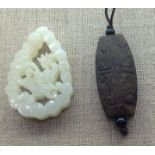 A CHINESE PALE GREEN JADE PENDANT Carved with a central butterfly and a flower enclosed by a border,