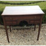 AN 18TH CENTURY OAK LOWBOY  With three crossbanded drawers and central kneehole, raised on square