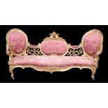 ATTRIBUTED TO MORAL & SEDDON An impressive gilt wood double spoon back settee, with central oval