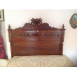 A LATE 19TH CENTURY FRENCH OAK DOUBLE BEDSTEAD  The heavily carved head and footboard, adorned