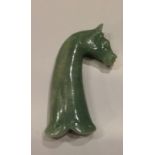 A MONGOLIAN JADE DAGGER HANDLE Carved with a horse's head with a flowing mane, parted to left.  (