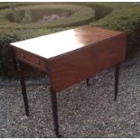 A GEORGIAN MAHOGANY PEMBROKE TABLE Having one real and one faux drawer, raised on ring turned legs