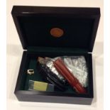 A ROLEX WATCH BOX Containing leather straps, links and a yellow metal Rolex strap buckle.