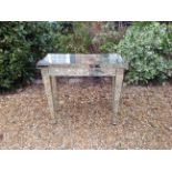 AN ART DECO STYLE PLANISHED MIRRORED SIDE TABLE Having a single drawer and raised on square tapering