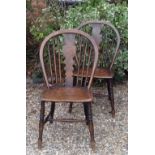 A PAIR OF 19TH CENTURY HOOP BACK COUNTRY CHAIRS  With solid elm seats, raised on turned legs.