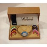 A LADIES GUCCI WRISTWATCH With changeable coloured bands and yellow metal bracelet, boxed and