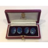 ASPREY A pair of oval cufflinks, with enamelled four leaf clovers on blue grounds, cased.