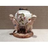 SITEZENDORF A porcelain oil lamp base, decorated with three winged cherubs holding a basket.  (