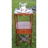 A GEORGIAN MAHOGANY SQUARE FORM WASHSTAND  With cut bowl and cup compartments, above a single drawer