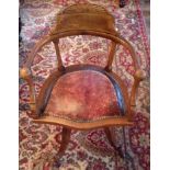 AN EDWARDIAN OAK AND POLLARD OAK DESK CHAIR The seat upholstered in Moroccan leather, raised on four