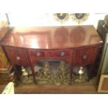 A LATE 18TH CENTURY MAHOGANY AND LINE INLAID BOW FRONTED SIDEBOARD  The central drawer flanked by