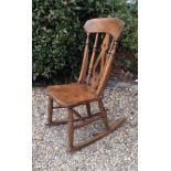 A VICTORIAN ASH AND ELM ROCKING CHAIR  Having a pierced splat back and supported on turned Roman