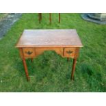 A 19TH CENTURY OAK LOWBOY With central kneehole flanked by two drawers, raised on turned legs with