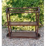 AN EDWARDIAN BEECH AND OAK BOBBIN TURNED TOWEL RAIL With cane shelves.