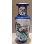 A 19TH CENTURY CHINESE FAMILLE VERTE VASE The blue body decorated with floral panels on cream