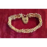 A 9CT ROSE GOLD GATELINK BRACELET  With padlock clasp. (l 18cm)