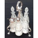 A VICTORIAN SILVER PLATED SIX BOTTLE CRUET STAND With beaded decoration, the cut glass bottles