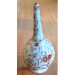 AN 18TH CENTURY CHINESE ROSE WATER SPRINKLER With floral decoration on a cream ground, raised on a