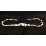 AN 18CT WHITE GOLD AND DIAMOND LINE BRACELET  Set with sixty-six stones. (7.8cm without clasp) (