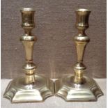 A PAIR OF GEORGE I BRASS CANDLESTICKS Having square bases, with cut corners. (approx 17½cm)