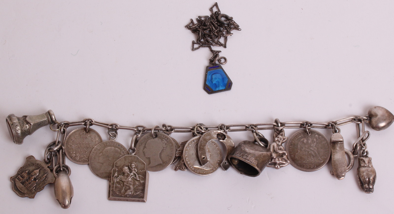 A SILVER CHARM BRACELET  Hung with eighteen charms, to include 20th Century coins, one being an 1852 - Image 2 of 2