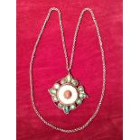 AN ORIENTAL SILVER, JADE AND CORAL MOUNTED PENDANT  Hung on a white metal chain.