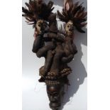 A CARVED AFRICAN TRIBAL ART PUNU/GABON  WOODEN MASK Shell decorated and having protruding lips and
