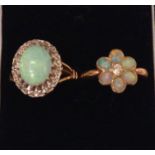 TWO 20TH CENTURY 18CT GOLD, OPAL AND DIAMOND RINGS The large cabochon cut central stone surrounded