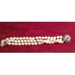 A 20TH CENTURY CULTURED PEARL, SAPPHIRE AND DIAMOND BRACELET Having three strands of pearls and a