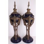 A PAIR OF NEOCLASSICAL ROYAL BLUE CERAMIC LAMP BASES Applied with brass floral swags and rams