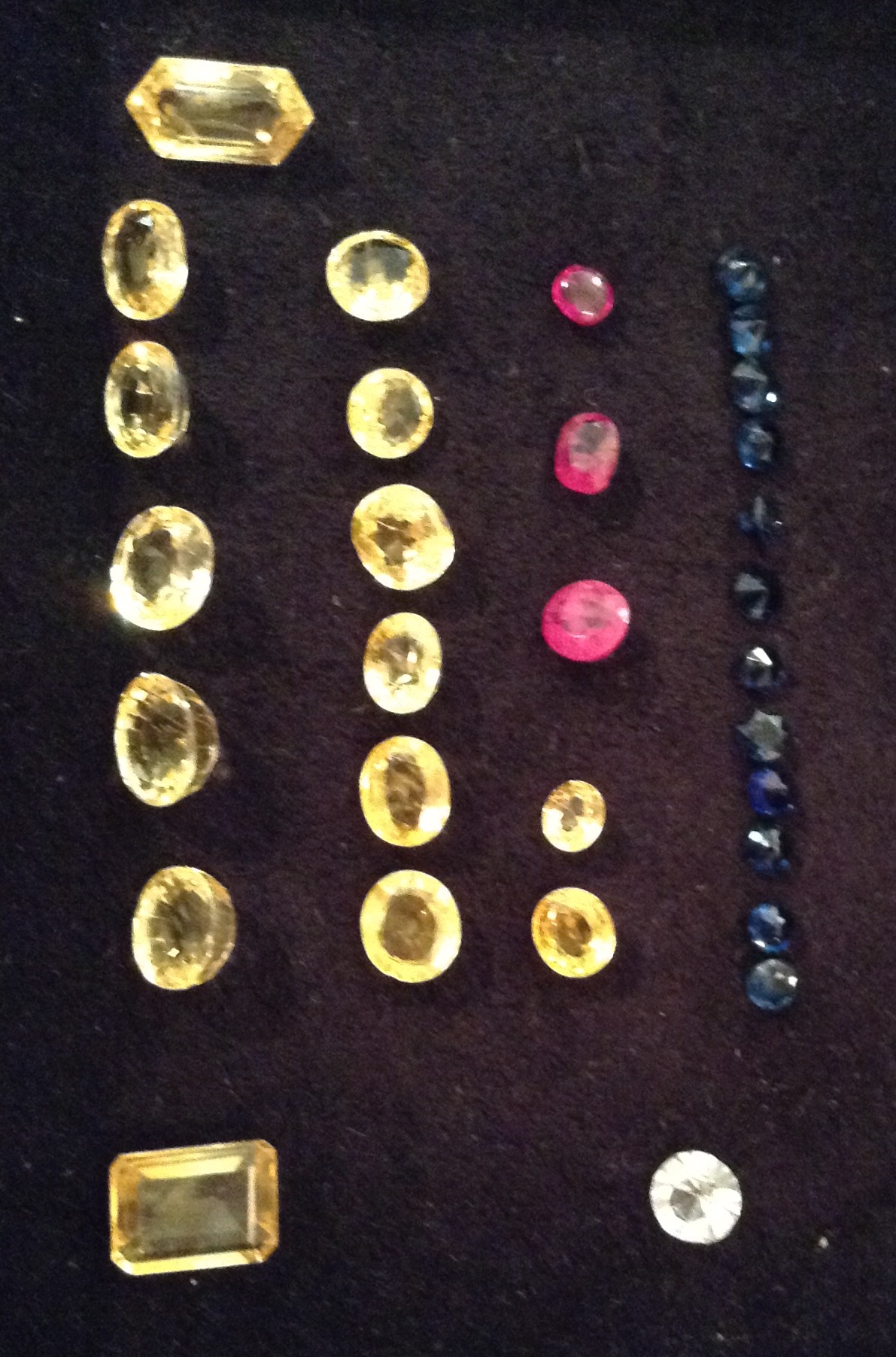 A COLLECTION OF CUT AND POLISHED GEM STONES To include fifteen various cut yellow sapphires,