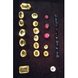 A COLLECTION OF CUT AND POLISHED GEM STONES To include fifteen various cut yellow sapphires,