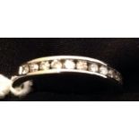 AN 18CT WHITE GOLD AND DIAMOND SET HALF ETERNITY RING. (800028-A-A)