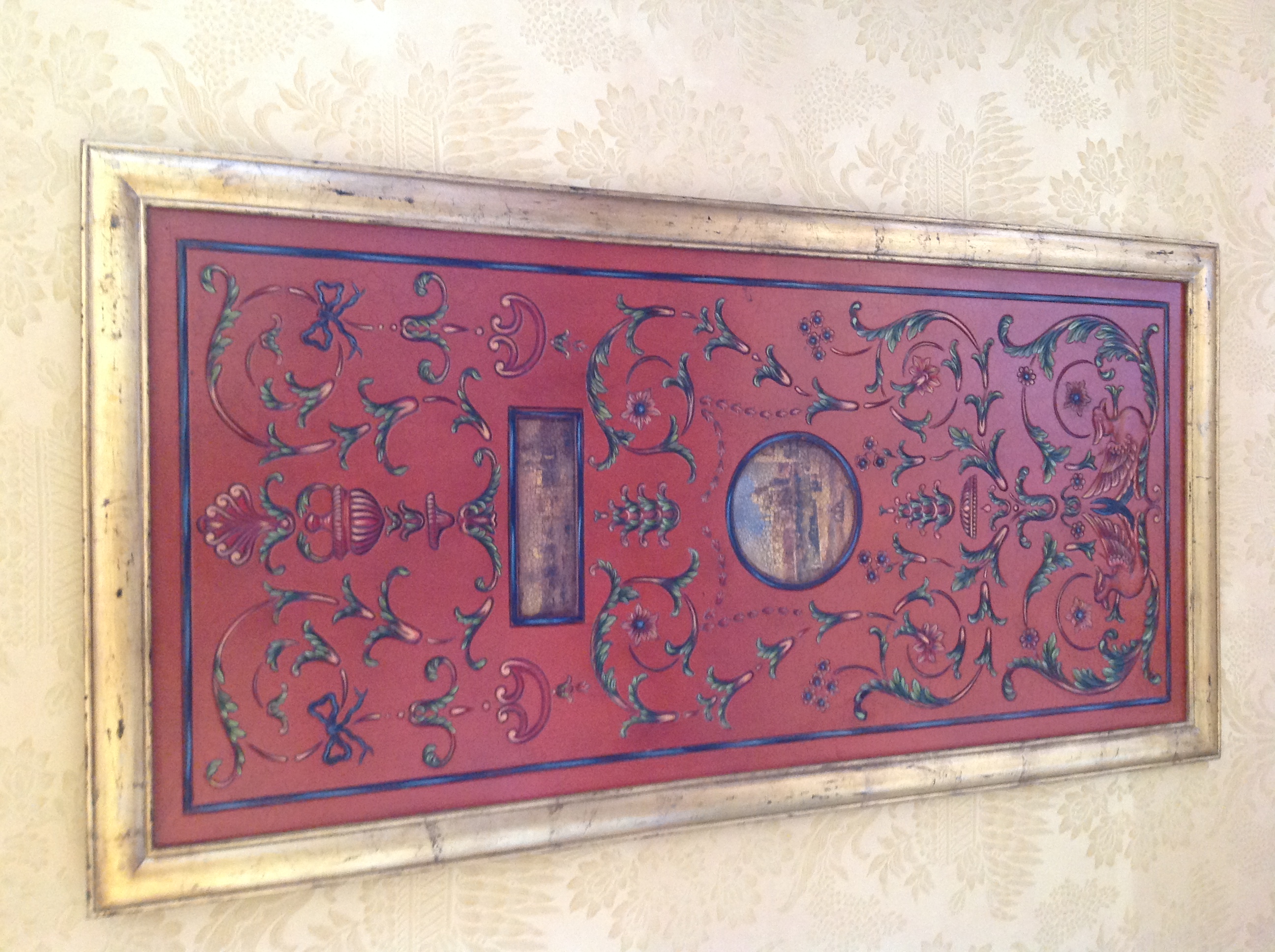 A DECORATIVE RED LACQUERED WALL PANEL  Inset with Venetian scenes.  (80cm x 160cm) Condition: good