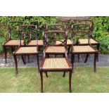 A SET OF EIGHT REGENCY PERIOD DINING CHAIRS With ropetwist and pierced backs above caned seats,