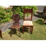 A LATE 19TH CENTURY FRENCH GOTHIC OAK HALL CHAIR Along with another having elaborately carved back