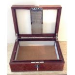 AN EARLY 20TH CENTURY AMBOYNA HUMIDOR  With chrome fittings, complete with key. (w 32cm x h 11cm)