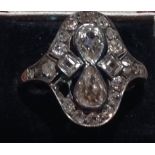 AN EDWARDIAN 18CT GOLD AND MULTI DIAMOND RING Set with two tear form diamonds flanked by two