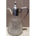 AN EDWARDIAN HALLMARKED SILVER AND CUT GLASS CLARET JUG The body mounted with a plain silver