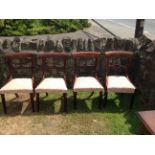 A MATCHED SET OF FOUR REGENCY ROSEWOOD BAR BACK DINING CHAIRS With carved and pierced rails,