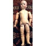 KESTNER, AN EARLY 20TH CENTURY BISQUE PORCELAIN HEADED DOLL On a composition body, with brown