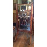 A GEORGE III PERIOD MAHOGANY CHEVAL MIRROR The central plate held on two turned columns, with