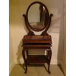 A VICTORIAN MAHOGANY OVAL TOILET MIRROR AND A MAHOGANY TWO TIER SIDE TABLE The mirror having three