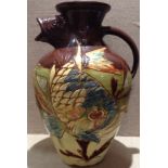 BRANNAM POTTERY, A LATE 19TH CENTURY JUG With a fish head spout, hand painted in brown, blue and