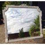 A LARGE EARLY 19TH CENTURY MIRROR The French grey finished frame carved with floral bouquets and