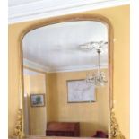 A VICTORIAN GILT WOOD FRAMED OVERMANTEL MIRROR  With arched silvered plate and scroll work