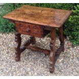 AN 18TH CENTURY SPANISH WALNUT OCCASIONAL TABLE With a single drawer, raised on chip carved lyre end